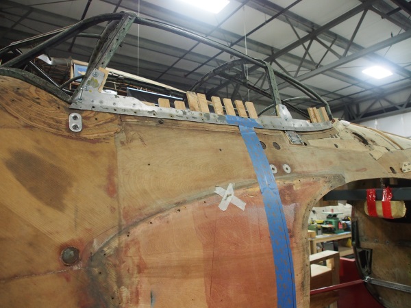The canopy frame reinstalled on the fuselage with wood shims and fairings. The fairing covers a number of sins, but mostly the very poor fit of the canopy frame. In his autobiography Sir Geoffrey notes that this was a constant annoyance and a failing in the design of the Mosquito.